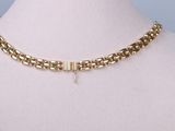 a close up of a gold chain necklace on a mannequin mannequin mannequin mannequin mannequin mannequin mannequin mann