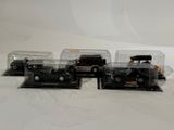 four toy cars that are sitting in a row on a table
