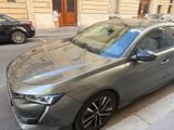 a silver car parked on the side of the street