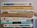 many books stacked on top of each other on a table