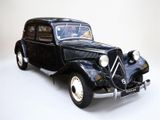 an old model of a black car on a white surface