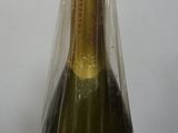 a bottle of champagne wrapped in plastic on a table