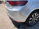 the rear end of a silver car parked in a parking lot