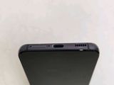 a close up of the back of a cell phone on a white surface