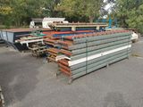 a lot of steel beams stacked up in a parking lot