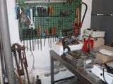 a workbench with many tools on it in a garage
