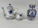 three blue and white vases sitting next to each other