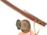 a person holding a small metal object in their hand