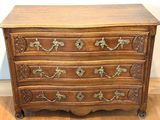 an old wooden chest of drawers with ornate carvings on the drawers