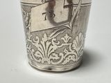 a silver cup that has a tag on it
