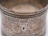 an old silver bowl with a decorative design on it