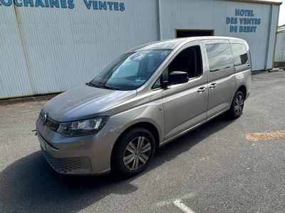 the silver van is parked in front of a building