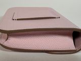leather case for a pink purse on a white surface