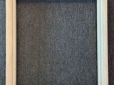 an empty wooden frame on a gray background
