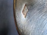 a close up of a metal object with a hole in it