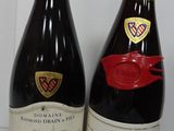 two bottles of wine sitting next to each other on a table
