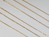 a collection of gold chain necklaces on a white background