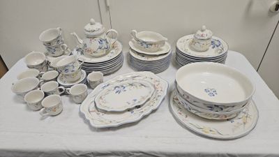 a table with a lot of dishes and cups on it