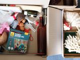 two boxes filled with toys and books on the floor