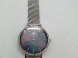 a close up of a watch on a table with a white background