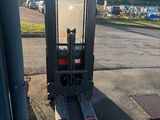a fork lift truck parked on the side of the road