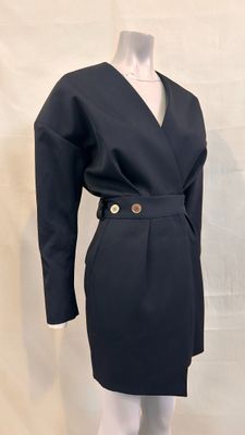 the dress is black and has a gold buckle on the waist
