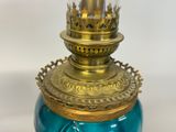 a blue glass vase with a gold top and a gold top