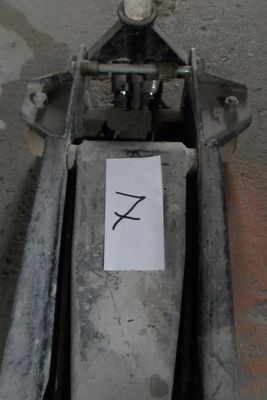 a sign on the back of a machine that is sitting on the ground