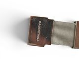 a close up of a metal object on a white surface
