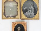 three framed photographs of a woman in a dress and a man in a dress