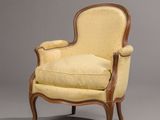 an old fashioned chair with a yellow upholstered upholstered seat