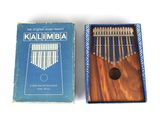 a box with a musical instrument in it and a box with a book