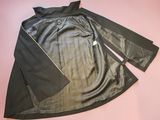 a close up of a black leather jacket on a pink surface