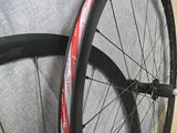the wheels of a bicycle are leaning against the wall
