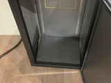 an image of a metal cabinet with a cup on it