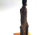 statue of a person sitting on a wooden block with a white background