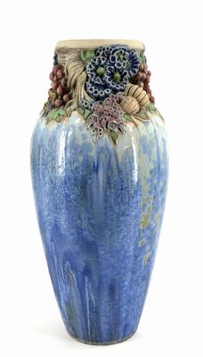 a blue vase that has a bunch of flowers on it