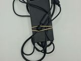 a black charger with a cord attached to it on a white surface