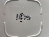 a white plate with a black and white design on it