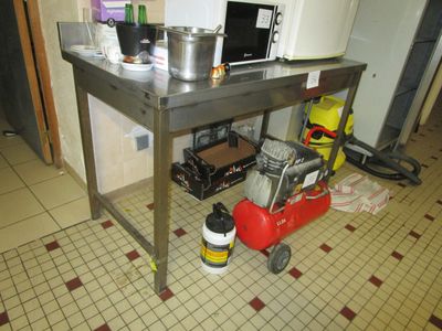 an image of a kitchen with a table and a red fire hydrant