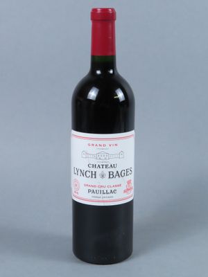 a picture of a bottle of wine with a red cap