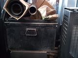 a pile of junk in a room with a tv on top of it