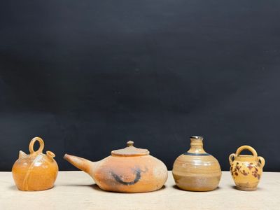several different types of vases are lined up on a table