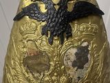 a gold helmet with a bird on top of it
