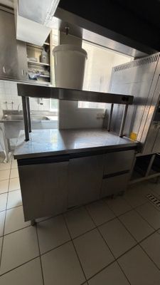 a large kitchen with stainless steel appliances and counters