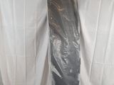 a surfboard that is wrapped in plastic and sitting on a table