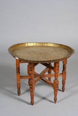 a gold tray on a wooden table on a white background