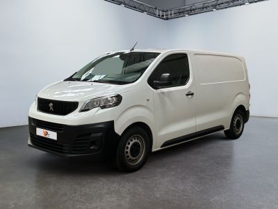 the small white van is parked in a large room