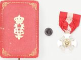 a red book with a gold medal and a red book with a red ribbon