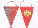 two pennants hanging from a rope on a white wall